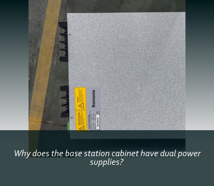 Why does the base station cabinet have dual power supplies?